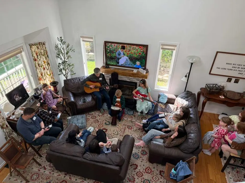 A living room full of people singing and talking
